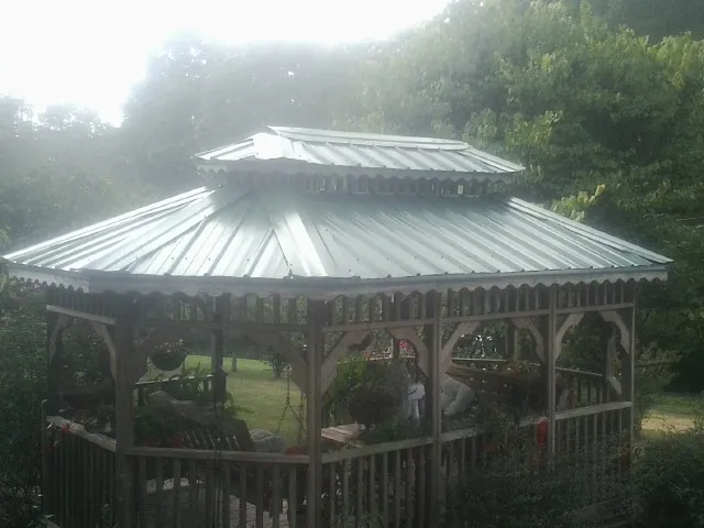 Two tier green metal roof on a garden gazebo in Canton